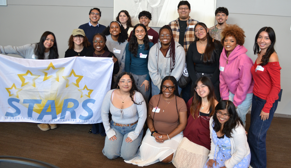 Group of STARS students holding STARS banner at an event.